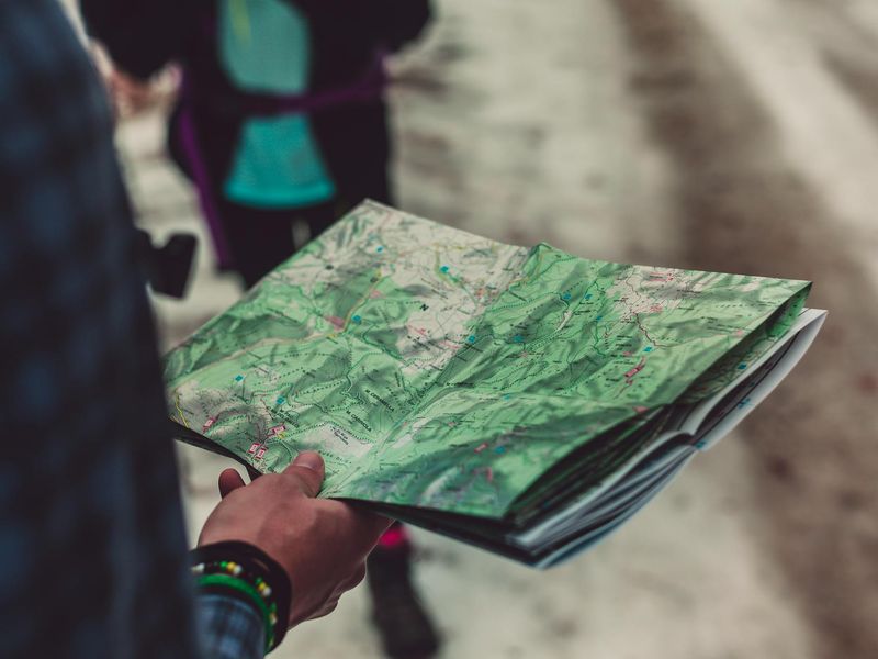 Backpacker planning route with map