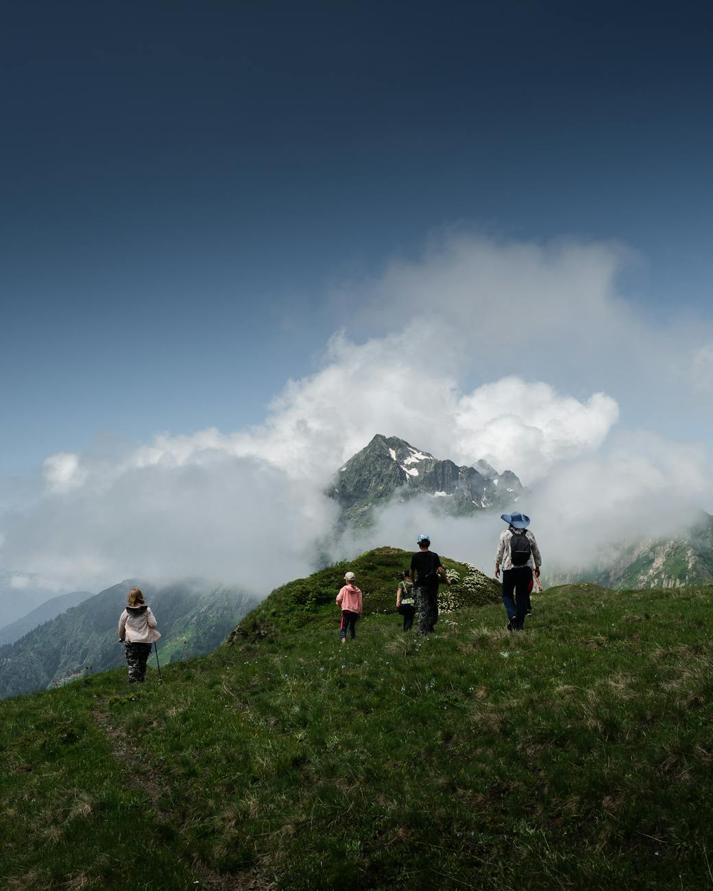 Diverse group of backpackers exploring mountain trail